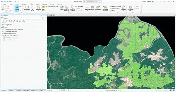 This image demonstrates the integration of Picterra with Esri's ArcGIS Pro, showcasing a seamless workflow between AI geospatial analysis and industry-standard GIS software. The interface displays an aerial map of a forested and agricultural region, with light green overlays indicating analyzed areas. The "Contents" pane on the left highlights various active projects, including Palm-Oil Monitoring, Solar Panel Detection, and Railway Bolts and Clips. By bringing Picterra's automated detection capabilities directly into the ArcGIS environment, users can easily combine AI-generated insights with complex spatial datasets for advanced environmental monitoring, infrastructure management, and land-use planning.